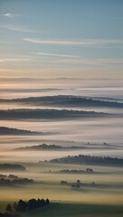 Naklejka premium Misty sunrise over rolling hills
