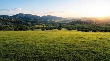 Sunset over grassy valley, mountains background, idyllic landscape, nature scene, travel postcard