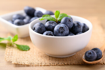 Blueberries in white bowl on wooden table, Healthy fruit, Food ingredient