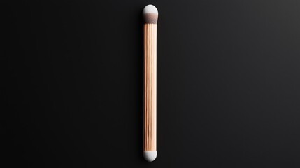 Obraz premium Rose gold makeup brush on black background; beauty product photography