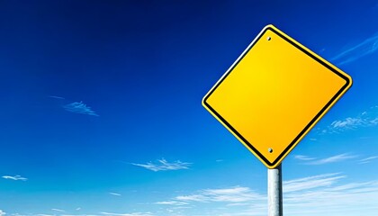 Blank Yellow Road Sign Against a Clear Blue Sky