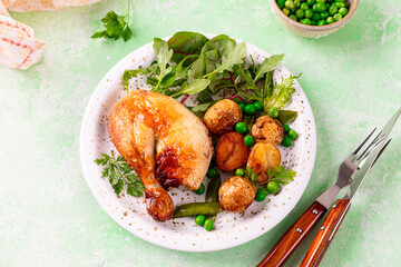 Spring lettuce leaves with new potatoes and baked chicken.