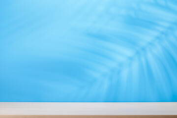Template with empty table and wall with natural plant shadow and sunny glare