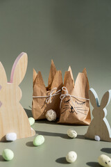DIY candid Easter present paper bag bunny arrangement decor. Series of handmade craft paper gift...