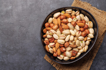 A vibrant assortment of various nuts, including almonds, walnuts, hazelnuts, cashews, and pistachios