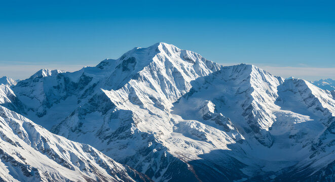 snow-capped mountain range under a clear blue sky