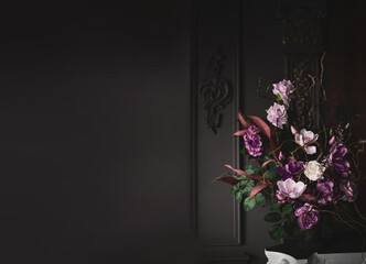 Bouquet of roses and bent branches, non-standard floral arrangement in a vintage vase on a...