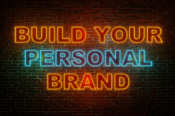 Fototapeta premium Build your personal brand. Brick wall at night with the text in orange and blue neon letters. 3D illustration