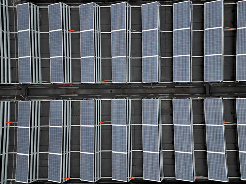 extensive roof of industrial and logistic hall are gradually being filled with solar panels. covering roofs helps industrial developer increase energy efficiency and sustainability site, building 