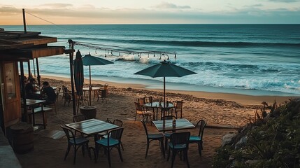 A serene beachside caf with tables overlooking the ocean and people enjoying drinks. picture