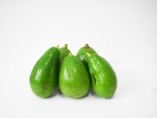 Freshly harvested avocado (Persea americana) fruit on a white background