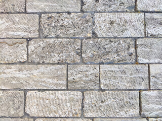 Textured stone background with gray bricks and clean lines for elegant design purposes