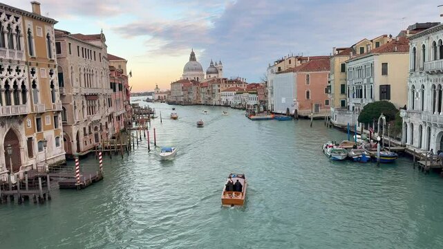 High-Angle View of Water Taxi Cruising Down Grand Canal Toward Santa Maria della Salute in Venice Italy