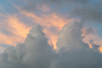 Mixed white, orange and gray clouds on a blue sky in Israel.
