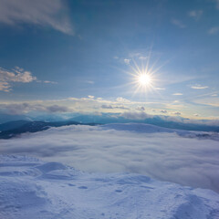 mountain ridge in snow under a sparkle sun