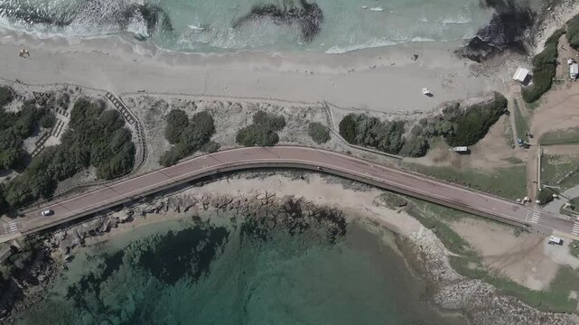 Drone footage of Rena di Ponente and Rena di Levante on Capo Testa, Sardinia, Italy, in summer, featuring white sand, turquoise waters, coastal dunes, and stunning Mediterranean landscapes.