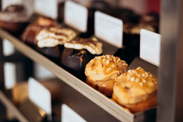 Appetizing cinnamon buns with cream in the bakery window.