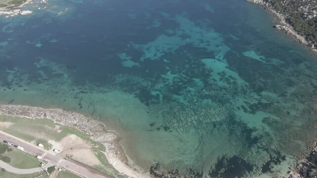 Drone footage of Rena di Ponente and Rena di Levante on Capo Testa, Sardinia, Italy, in summer, showcasing golden sand, turquoise waters, rolling dunes, and stunning Mediterranean coastal scenery.