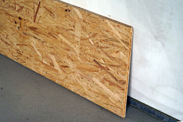 A chipboard leaning against a wall.
