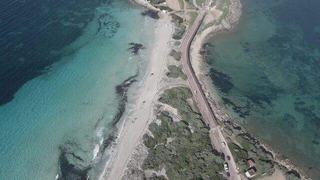 Drone footage of Rena di Ponente and Rena di Levante on Capo Testa, Sardinia, Italy, in summer, showcasing golden sand, turquoise waters, rolling dunes, and breathtaking Mediterranean scenery.