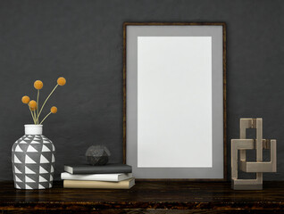Black mock up poster frame on dark plaster wall with yellow flowers in a pot, books and geometric props on wooden table; portrait orientation; stylish frame mock up; 3d rendering, 3d illustration