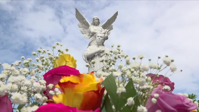 close up of the face of Ruben Dario statue in Nicaragua during festivities of his birthday, flowers moving in the foreground