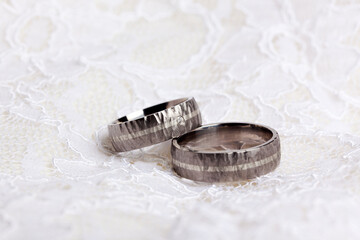 Pair of wedding rings on white lace