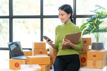 Smiling Businesswoman in Home Office: A young businesswoman exudes confidence as she manages her...