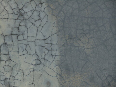 Close-up of a cracked and weathered surface with intricate patterns. Ideal for textures, backgrounds, and abstract design projects. - Powered by Adobe