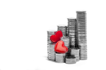 Two Fiery Red Hearts on Towers of Silver Coins. Valentine's Day. Love. White Background. Place for...