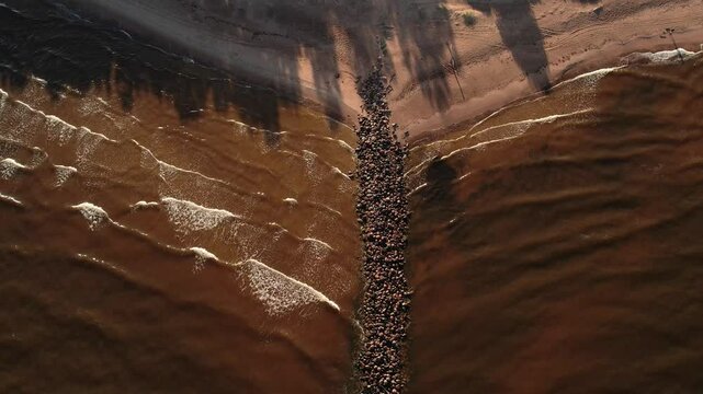 Aerial View of Coastal Beachline with Rocky Formation Amidst Sea Waves. Latvia. Village Tuja