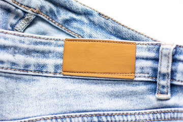 fragment of blue jeans with a brown tags A blank blue jeans leather label Denim Label Mockup