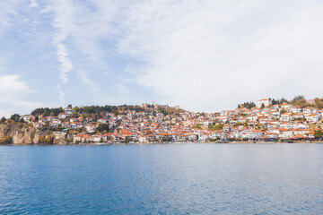 Fototapeta premium Picturesque view of Ohrid, North Macedonia, a historic town on Lake Ohrid shore, known for its charming architecture and stunning lake views, making it a popular tourist destination.