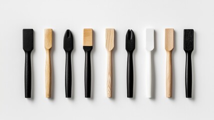 Minimalist wooden and black spreaders on white.  Food prep tools flatlay. Recipe blog use