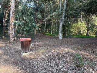 Public park on the island of Cyprus. Installed garbage bins and informational prohibiting and permitting signs, infographics.