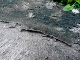 A layer of peeling plaster on the surface of a concrete wall can be used as a background.