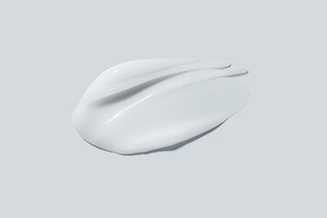White cream balm swatch cosmetic product isolated on light grey
