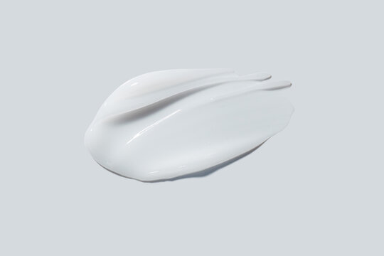 White cream balm swatch cosmetic product isolated on light grey