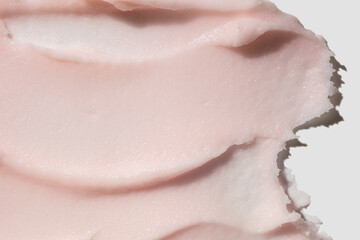 Cosmetic products creamy pink texture smudge grey isolated background