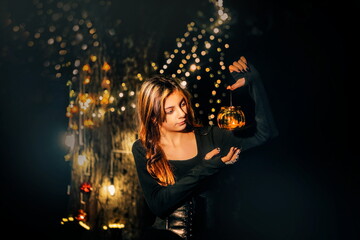 Girl with a flashlight in a magical forest