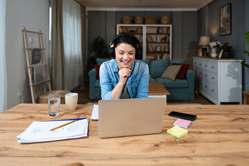 Young freelance businesswoman attending online educational class on laptop computer webcam...