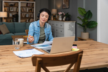 Young freelance businesswoman attending online educational class on laptop computer webcam teleconference in progress watching and listening educator expert about economy and finance. Online business