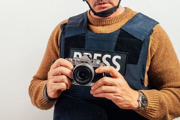 Reporter in bulletproof vest with a camera.