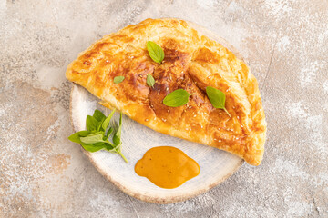 Fried homemade khachapuri cake with cheese and meat, fried in pan. Top view