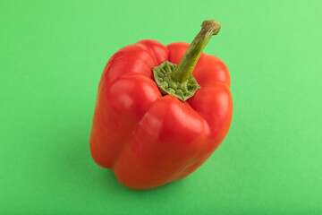 Red pepper on green pastel, Side view, copy space.