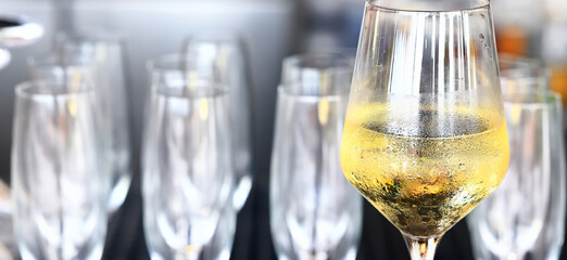 a glass of white wine served in a restaurant, abstract background of a summer restaurant