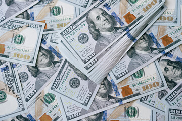 Fototapeta premium Pile of US One Hundred Dollar Bills Representing Wealth and Financial Success