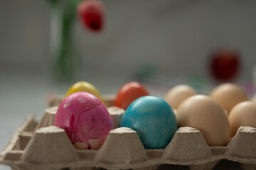 A vibrant collection of decorated Easter eggs arranged in a carton, perfect for joyful spring celebrations