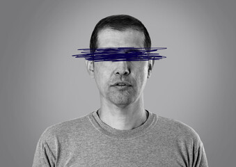 Close-up of a man with lines on his eyes made with a blue pen in a concept of censorship