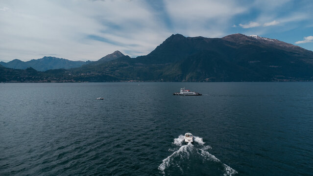 Aerial view of boat trip near Bellano, panoramic view from the drone to the famous old Italy town of Como lake. Near Varenna and Lierna, Bellano is a small town in Como, near Lecco, in Lombardia.